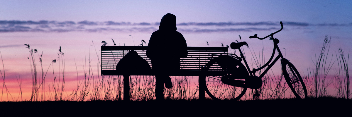 A person sitting quietly in soft evening light, reflecting and resting after an emotionally overwhelming day.